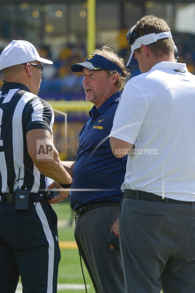 Craig Hudson West Virginia coach Dana Holgorsen speaks with an official during the first half of an NCAA college football game against Kansas in Morgantown, W. Va., Saturday Oct. 6, 2018. (AP Photo/Craig Hudson)