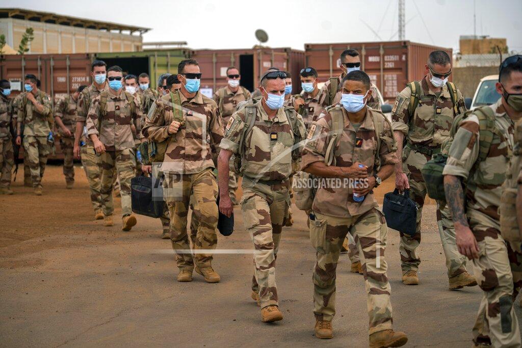 Uncredited French Barkhane force soldiers who wrapped up a four-month tour of duty in the Sahel leave their base in Gao, Mali Wednesday June 9, 2021. After France suspended joint military operations with Malian forces after the junta led by Col. Assimi Goita retook control of Mali's transitional government May 24 2021, French President Emmanuel Macron announced at a press conference Thursday June 10, 2021 That operation Barkhane would end and be replaced by support for local partners and counter terrorism. (AP Photo/Jerome Delay)