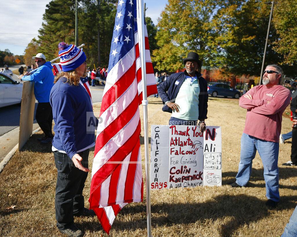 Todd Kirkland Protesters and supporters wait at the gate to the Atlanta Falcons' training facility where free agent quarterback Colin Kaepernick was set to workout for NFL football scouts, Saturday, Nov. 16, 2019, in Flowery Branch, Ga. The workout was moved to a high school in Riverdale, Ga. (AP Photo/Todd Kirkland)