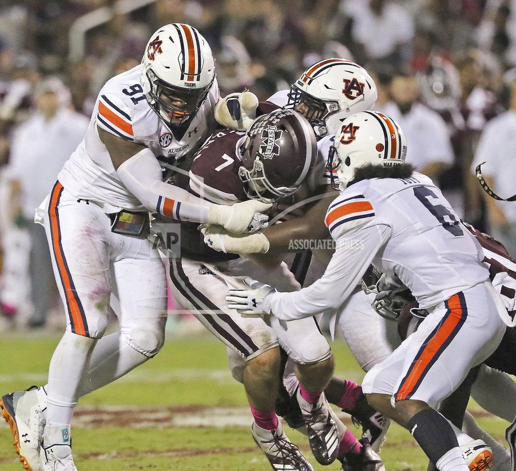 Jim Lytle Auburn's lineman Nick Coe (91) and Christian Tutt (6) help tackle Mississippi State quarterback Nick Fitzgerald (7) during the second half of an NCAA college football game Saturday, Oct. 6, 2018, in Starkville, Miss. MSU won 23-9. (AP Photo/Jim Lytle)