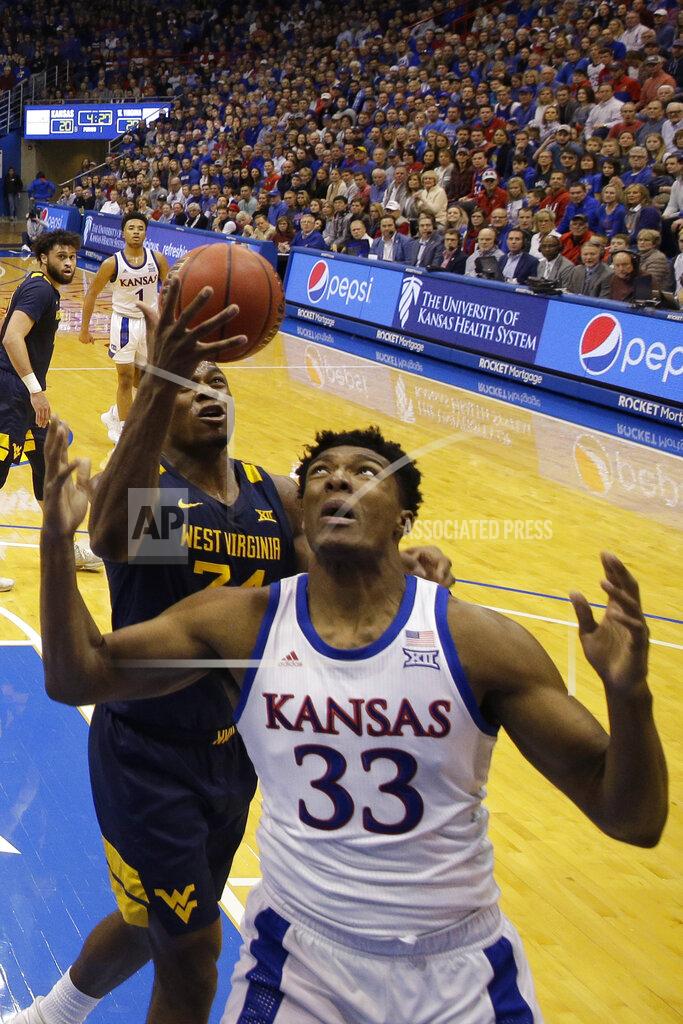 Charlie Riedel West Virginia's Oscar Tshiebwe (34) steals the ball from Kansas' Udoka Azubuike (35) during the first half of an NCAA college basketball game Saturday, Jan. 4, 2020, in Lawrence, Kan. (AP Photo/Charlie Riedel)