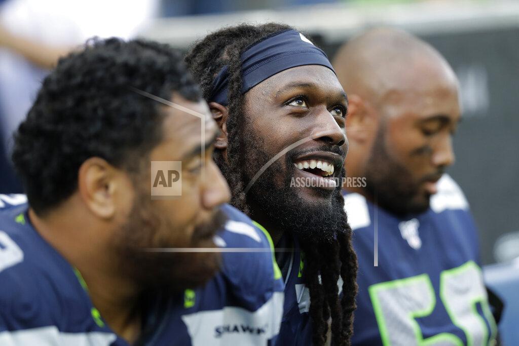 John Froschauer Seattle Seahawks defensive end Jadeveon Clowney, center, sits on the bench with teammates late in the second half of an NFL football game against the Cincinnati Bengals, Sunday, Sept. 8, 2019, in Seattle. (AP Photo/John Froschauer)