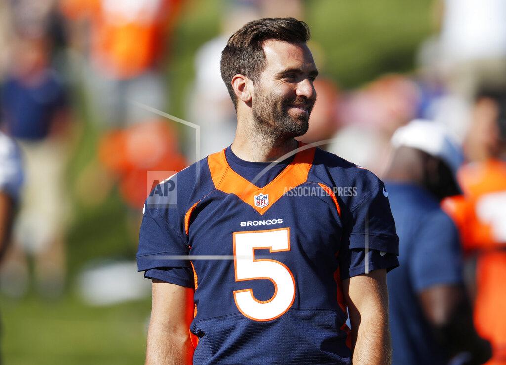 David Zalubowski Denver Broncos quarterback Joe Flacco jokes with teammates as they take part in drills during an NFL football training camp session Tuesday, Aug. 6, 2019, in Englewood, Colo. (AP Photo/David Zalubowski)