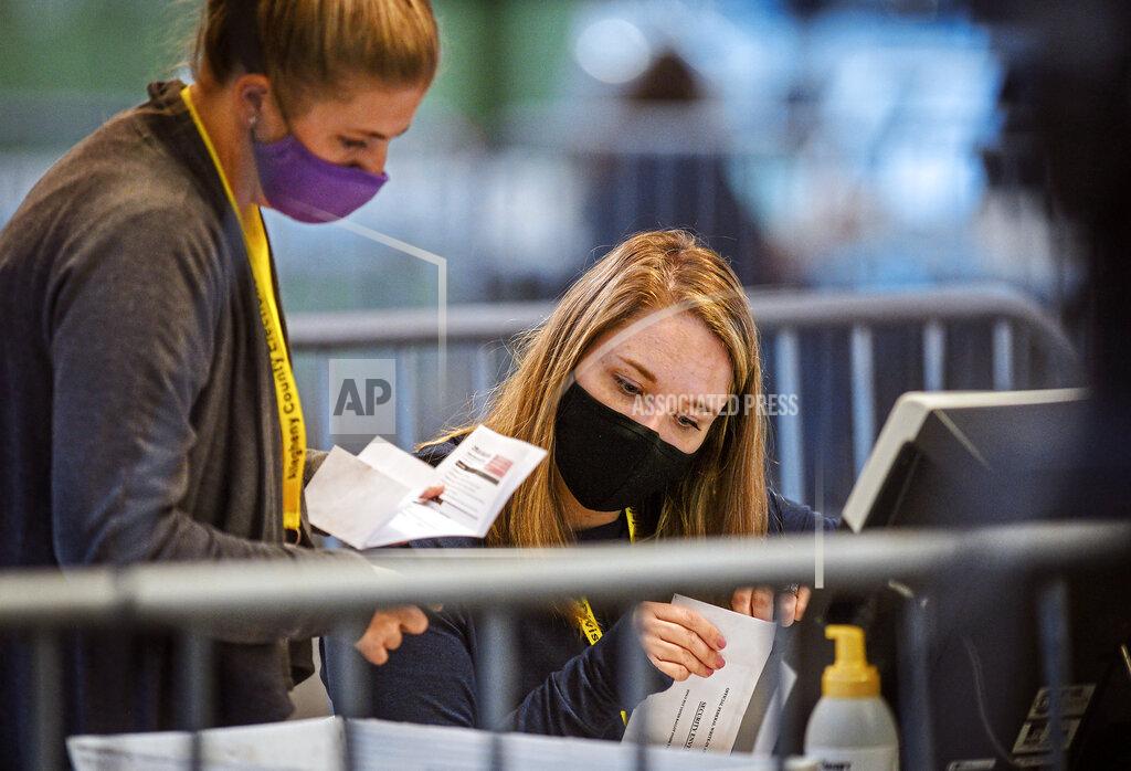 Members of the Allegheny County Return Board process the remaining absentee and mail-in Allegheny County ballots, Thursday, Nov. 12, 2020, on the North Side in Pittsburgh. (Steve Mellon/Pittsburgh Post-Gazette via AP)