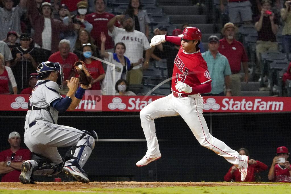 Mark J. Terrill Los Angeles Angels designated hitter Shohei Ohtani, right, avoids a tag by Houston Astros catcher Jason Castro but misses the plate during the 10th inning of a baseball game Wednesday, Sept. 22, 2021, in Anaheim, Calif. Ohtani was later tagged out by Castro. (AP Photo/Mark J. Terrill)