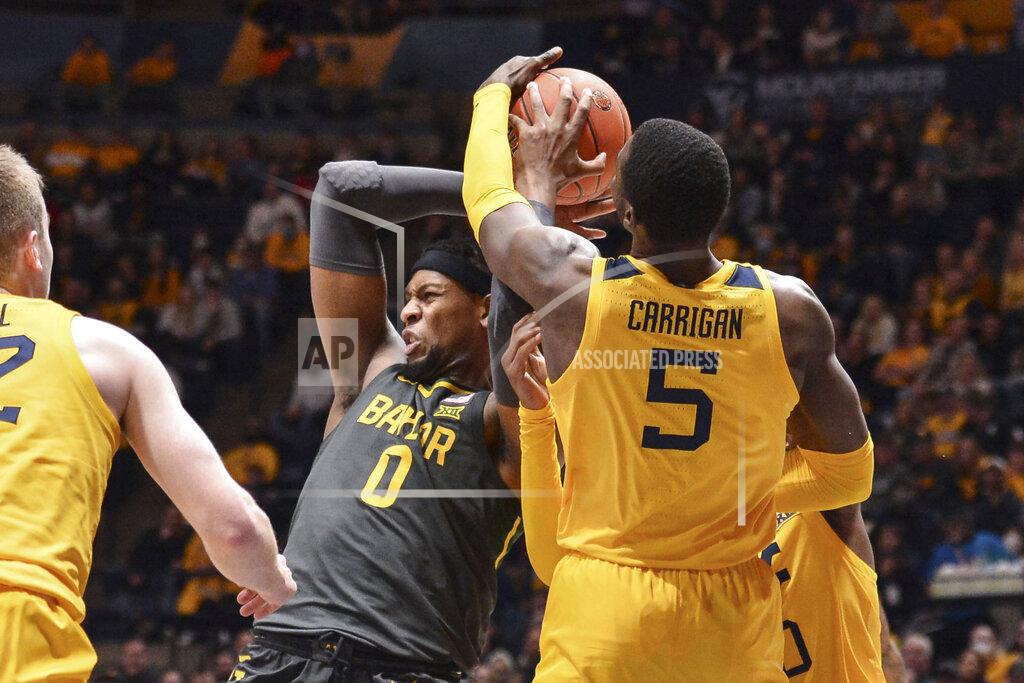 William Wotring Baylor forward Flo Thamba (0) and West Virginia forward Dimon Carrigan (5) vie for a loose ball during the second half of an NCAA college basketball game in Morgantown, W.Va., Tuesday, Jan. 18, 2022. (William Wotring)