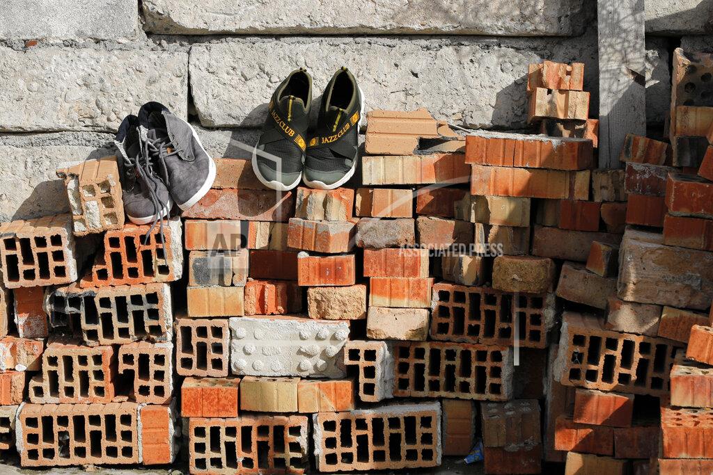 Vadim Ghirda Shoes are placed on a pile of bricks to dry in the yard of the Topchu family house in a village on the outskirts of Burgas, Bulgaria, Monday, Sept. 28, 2020. Human rights activists and experts say local officials in several countries with significant Roma populations have used the pandemic to unlawfully target the minority group, which is Europe's largest and has faced centuries of severe discrimination. (AP Photo/Vadim Ghirda)
