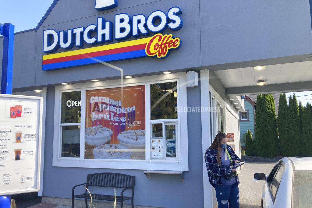 Andrew Selsky An employee of Dutch Bros Coffee in Salem, Ore., takes an order from a customer on Wednesday, Sept. 15, 2021. After humble beginnings as a pushcart operation decades ago in an Oregon town and growing into a company with hundreds of drive-thru coffee shops in about a dozen U.S. states, Dutch Bros Coffee on Wednesday launched an initial public offering on the New York Stock Exchange. (AP Photo/Andrew Selsky)
