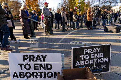 People listen during an anti-abortion rally outside of the Supreme Court in Washington, Tuesday, Nov. 30, 2021, as activists begin to arrive ahead of arguments on abortion at the court in Washington.(AP Photo/Andrew Harnik)