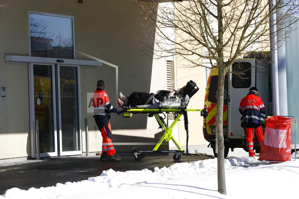 Petr David Josek Medical workers move a covid-19 patient at a hospital overrun by the covid pandemic in Cheb, Czech Republic, Friday, Feb. 12, 2021. The Czech government has imposed a complete lockdown of the three hardest-hit counties to help contain the spread of a highly contagious variant of the coronavirus. The meeasures will became effective Friday for the two counties in western Czech Republic on the German border Cheb and Sokolov and another county in the northern part of the country Trutnov located on the border with Poland. (AP Photo/Petr David Josek)