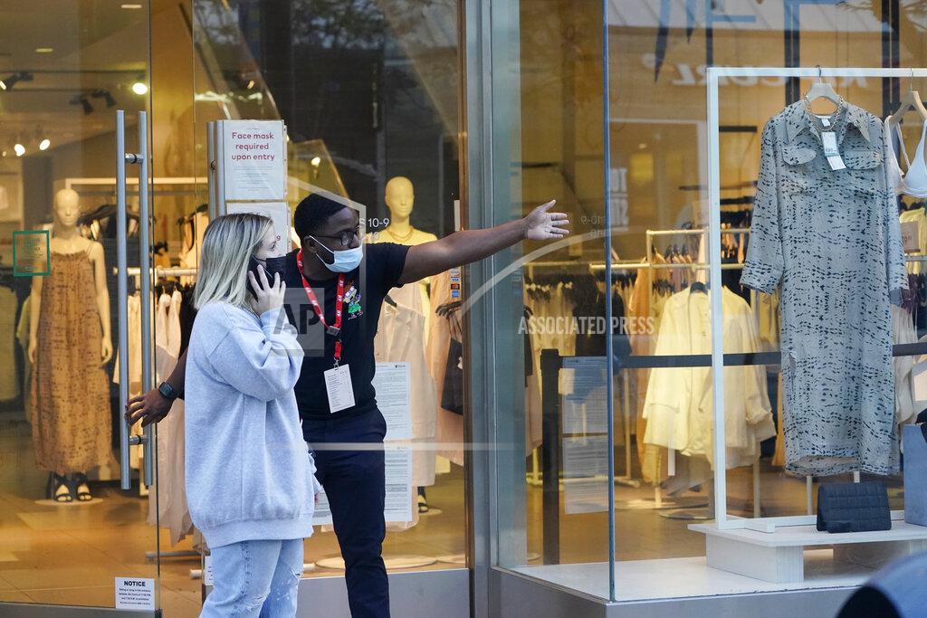 Marcio Jose Sanchez A salesperson gives directions to a shopper amid the COVID-19 pandemic on The Promenade Wednesday, June 9, 2021, in Santa Monica, Calif. (AP Photo/Marcio Jose Sanchez)