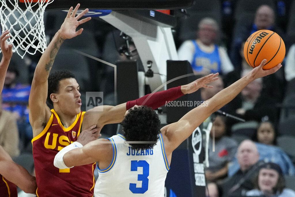 John Locher UCLA's Johnny Juzang (3) shoots around Southern California's Kobe Johnson (2) during the second half of an NCAA college basketball game in the semifinal round of the Pac-12 tournament Friday, March 11, 2022, in Las Vegas. (AP Photo/John Locher)