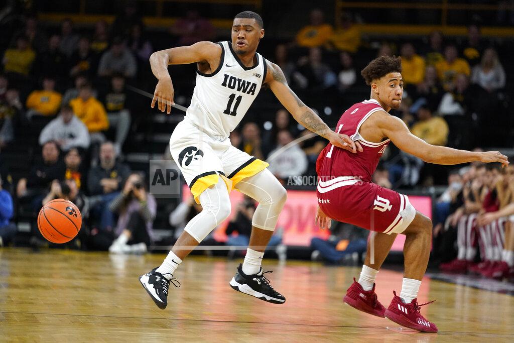 Charlie Neibergall Iowa guard Tony Perkins (11) fights for a loose ball with Indiana guard Rob Phinisee (1) during the first half of an NCAA college basketball game, Thursday, Jan. 13, 2022, in Iowa City, Iowa. (AP Photo/Charlie Neibergall)