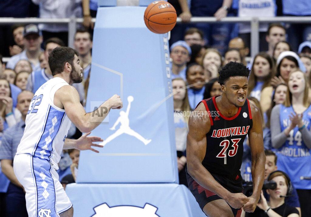 Gerry Broome Louisville's Steven Enoch (23) reacts following a basket while North Carolina's Luke Maye reaches for the ball during the first half of an NCAA college basketball game in Chapel Hill, N.C., Saturday, Jan. 12, 2019. Louisville won 83-62. (AP Photo/Gerry Broome)