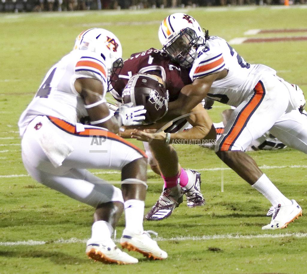 Jim Lytle Mississippi State quarterback Nick Fitzgerald (7) drives into Auburn defenders Daniel Thomas, left and Jeremiah Dinson right, and into the end zone for a touchdown during the first half of their NCAA college football game on Saturday, Oct. 6, 2018, in Starkville, Miss. (AP Photo/Jim Lyle)