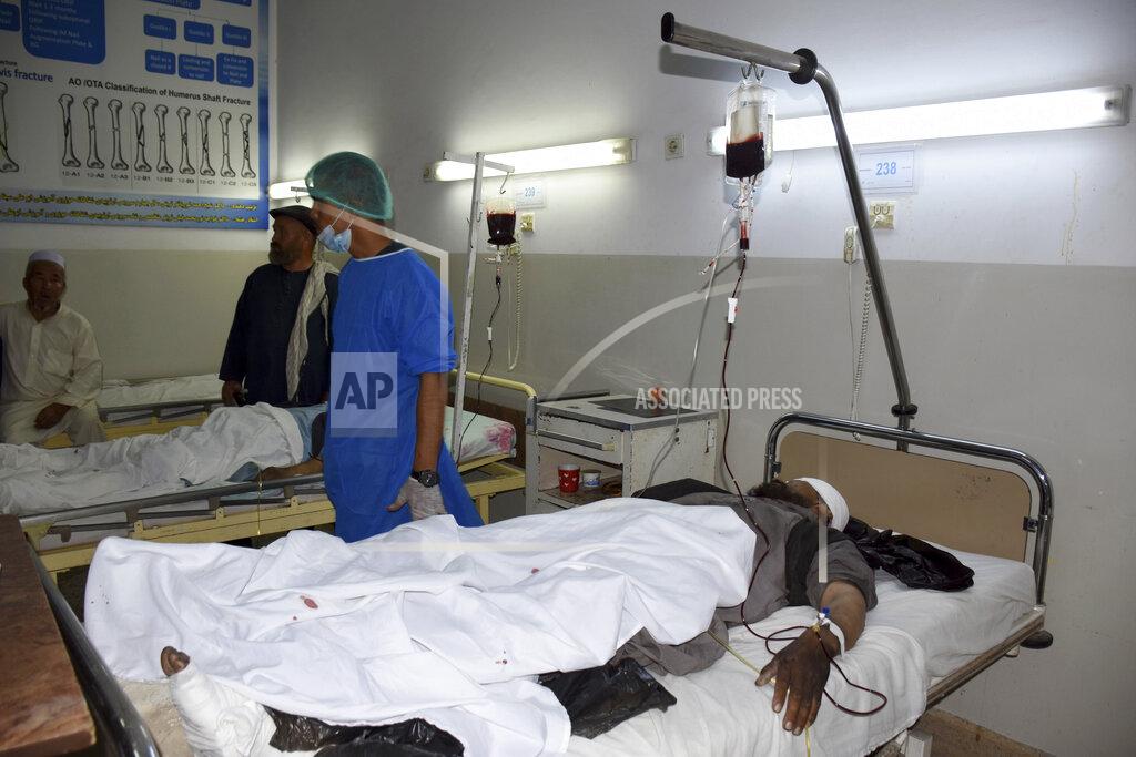 Masih Paeiz Wounded men receive treatment in a hospital, after a bombing in Mazar-e-Sharif, northern Afghanistan, Wednesday, May 25, 2022. A series of explosions shook Afghanistan on Wednesday, the Taliban said, including a blast inside a mosque in the capital of Kabul that killed at least five worshippers and three bombings of minivans in the country's north that killed nine passengers. (AP Photo/Masih Paeiz)