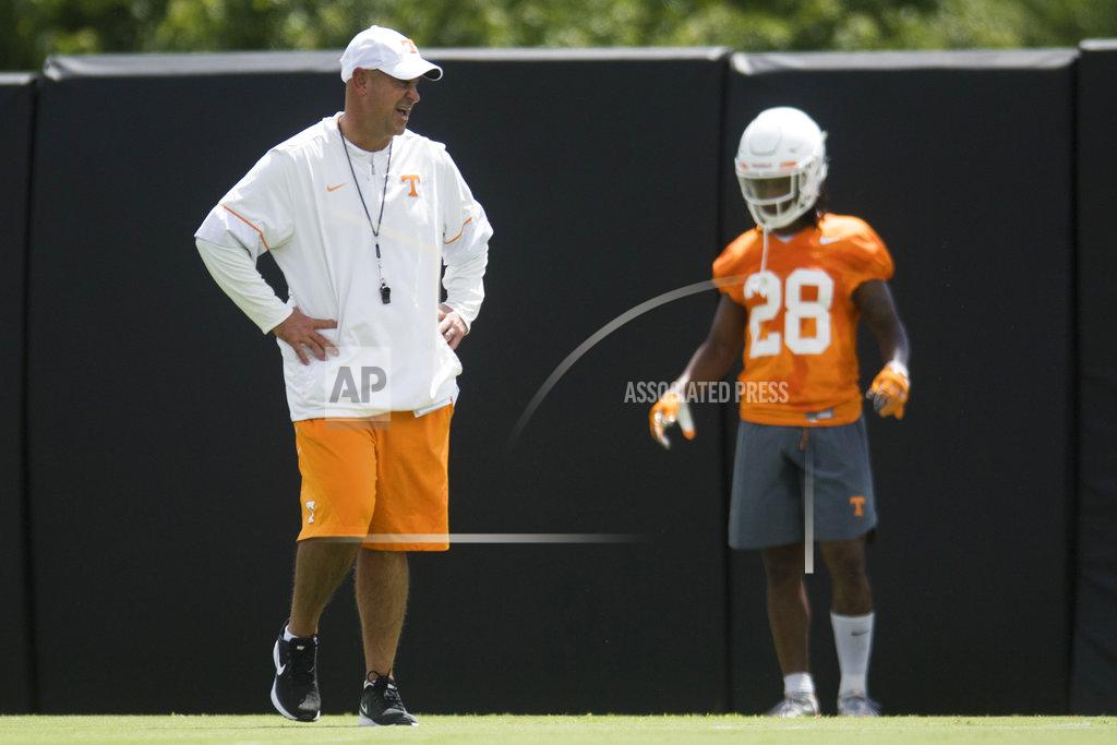 Tennessee head coach Jeremy Pruitt, left, stands on the field during the first NCAA college football practice of the season in Knoxville, Tenn., Friday, Aug. 3, 2018. (Caitie McMekin/Knoxville News Sentinel via AP)