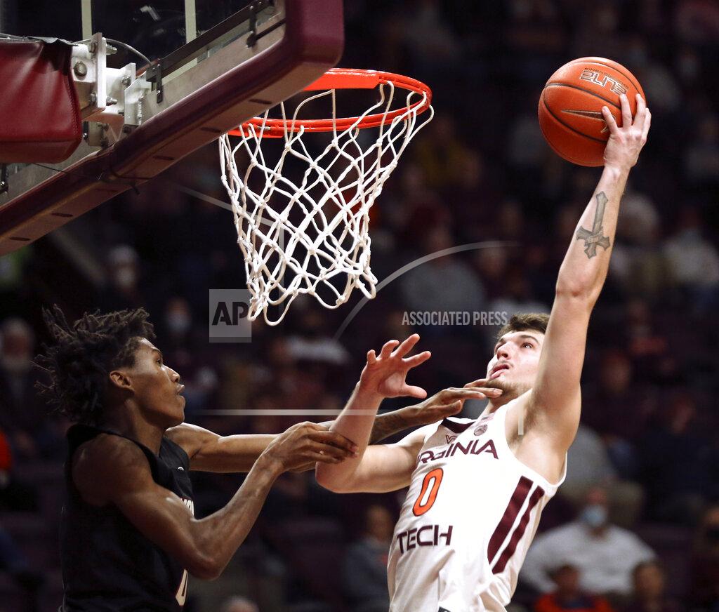 Matt Gentry Virginia Tech's Hunter Cattoor, right, is fouled by North Carolina State's Terquavion Smith (0) during the second half of an NCAA college basketball game Tuesday, Jan. 4, 2022, in Blacksburg, Va. (Matt Gentry/The Roanoke Times via AP)
