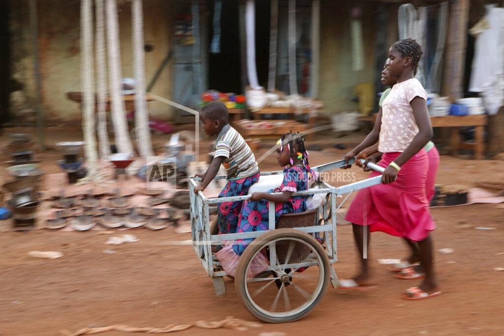 Sam Mednick Girls push children in a cart near the market in the town of Hounde, Tuy Province, in southwestern Burkina Faso on Thursday, June 11, 2020. (AP Photo/Sam Mednick)