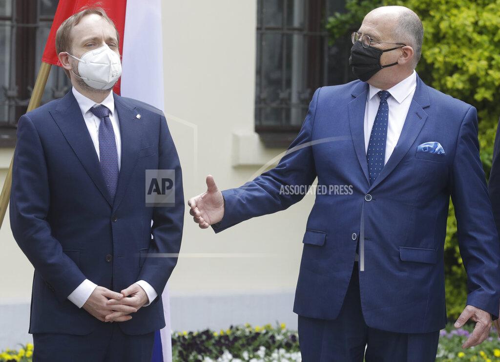Czarek Sokolowski Poland's Foreign Minister Zbigniew Rau,right,, gestures toward Czech Minister Jakub Kulhanek, ahead of a meeting with regional counterparts in Lodz, Poland, Friday, May 14, 2021.(AP Photo/Czarek Sokolowski)