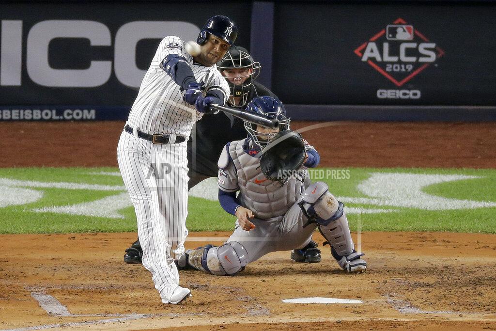 Seth Wenig FILE - In this Oct. 18, 2019, file photo, New York Yankees' Aaron Hicks connects for a three-run home run against the Houston Astros during the first inning of Game 5 of baseball's American League Championship Series, in New York. Yankees general manager Brian Cashman is optimistic Aaron Judge, James Paxton, Aaron Hicks and Giancarlo Stanton will be ready to play in time for New York's rescheduled opener at World Series champion Washington on July 23.(AP Photo/Seth Wenig, File)