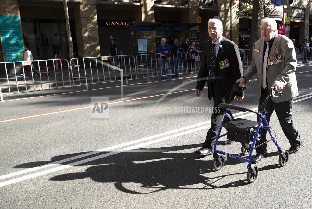 Mark Baker Veterans march during the Anzac Day parade in Sydney, Australia, Sunday, April 25, 2021. Australians and New Zealanders paid tribute to their war dead Sunday as both nations prepared to withdraw from their longest war in Afghanistan. (AP Photo/Mark Baker)