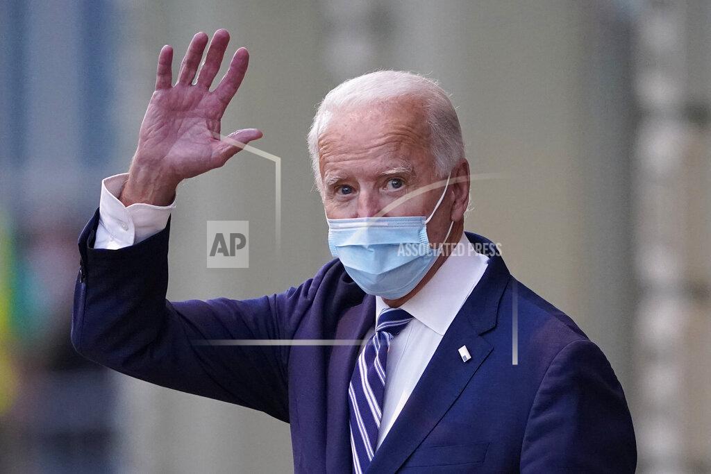 President-elect Joe Biden wavs as he leaves The Queen theater, Tuesday, Nov. 10, 2020, in Wilmington, Del. (AP Photo/Carolyn Kaster)