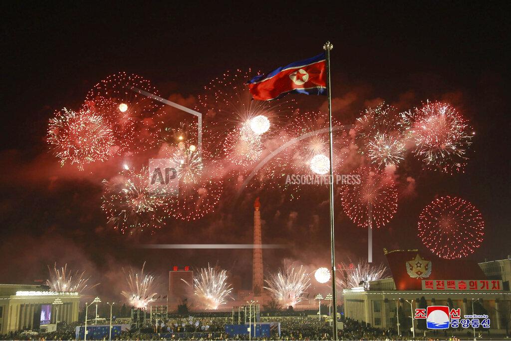 Uncredited In this photo provided by the North Korean government, fireworks illuminate the night sky, marking the New Year, as crowds of people look on, at Kim Il Sung Square in Pyongyang, North Korea, early Friday, Jan. 1, 2021. (Korean Central News Agency/Korea News Service via AP)