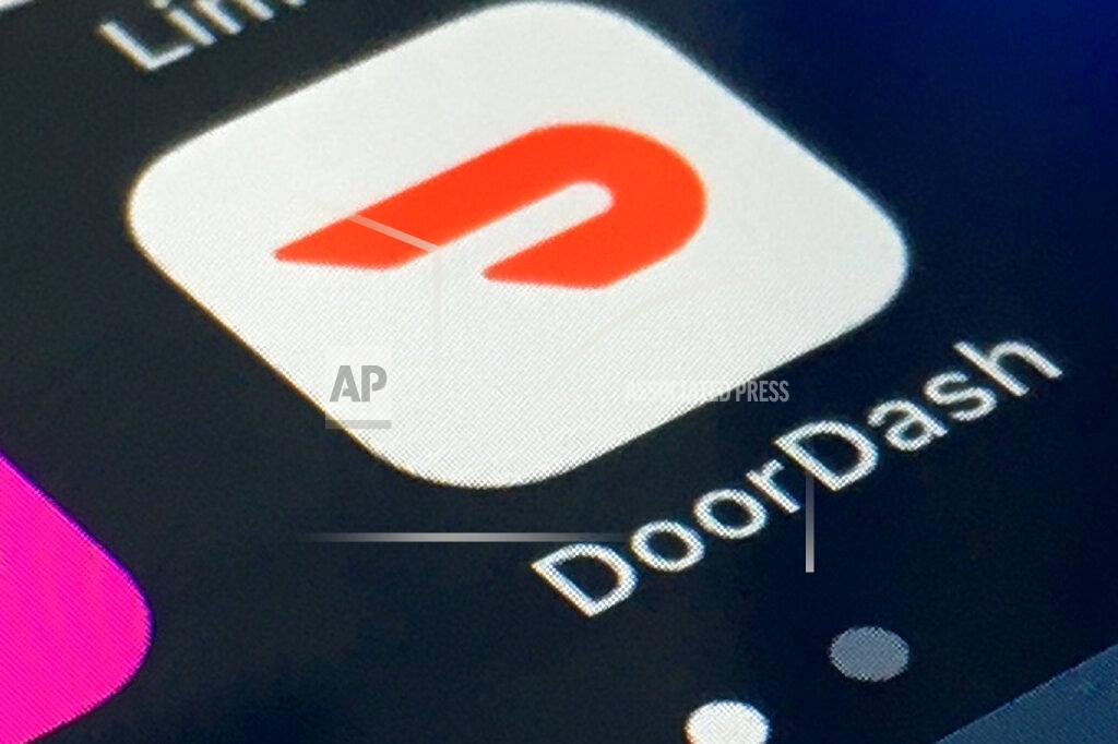 Uncredited FILE - The DoorDash app is shown on a smartphone on Feb. 27, 2020, in New York. In 2020, many people took to working remotely in sweatpants, hopped onto an expensive high-tech exercise bike and had their favorite restaurant dish delivered, perhaps by a driver trying to earn an extra buck and hoping not to catch the coronavirus. (AP Photo)