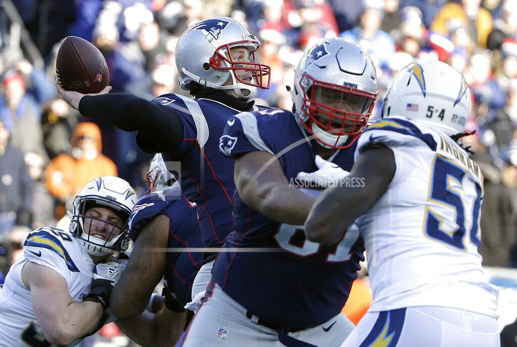 Steven Senne New England Patriots quarterback Tom Brady, center, passes under pressure from Los Angeles Chargers defensive end Melvin Ingram (54) during the first half of an NFL divisional playoff football game, Sunday, Jan. 13, 2019, in Foxborough, Mass. (AP Photo/Steven Senne)