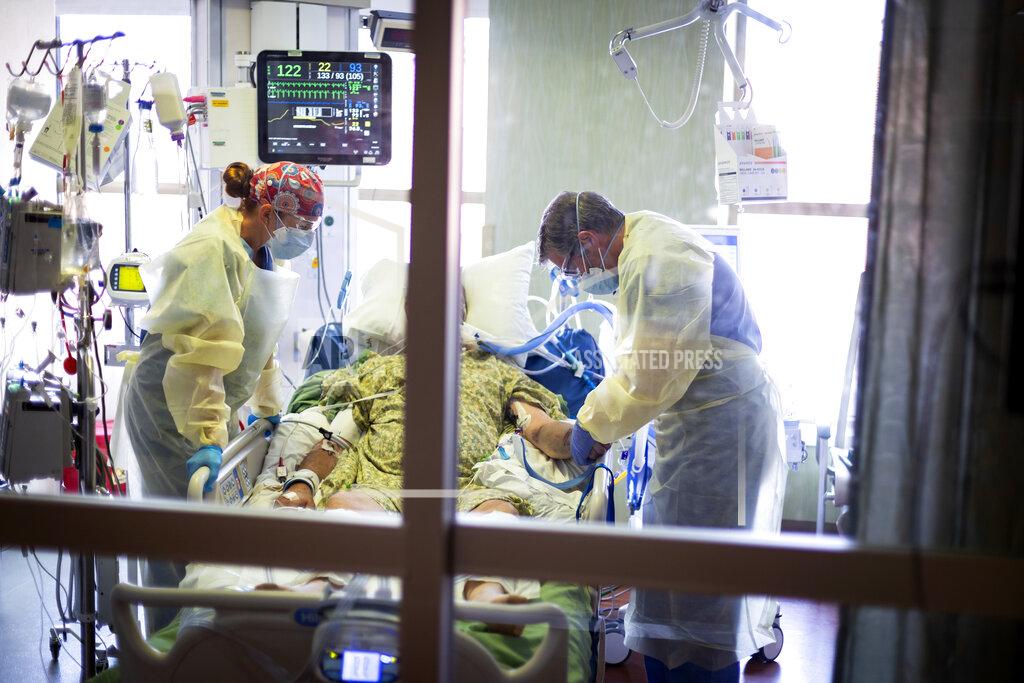 Kyle Green FILE - In this Aug. 31, 2021, file photo, Dr. William Dittrich M.D. looks over a COVID-19 patient in the Medical Intensive care unit (MICU) at St. Luke's Boise Medical Center in Boise, Idaho. The summer that was supposed to mark America’s independence from COVID-19 is instead drawing to a close with the U.S. more firmly under the tyranny of the virus, with deaths per day back up to where they were in March 2021. (AP Photo/Kyle Green, File)