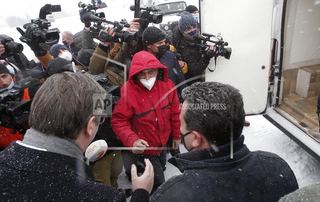 Boris Grdanoski Serbia's President Aleksandar Vucic, bottom left, and North Macedonia's Prime Minister Zoran Zaev, bottom right, talk to a health worker, center, at the border crossing Tabanovce, between North Macedonia and Serbia, on Sunday, Feb. 14, 2021. Serbia which has launched a successful vaccination campaign has donated some 8,000 doses of Pfizer COVID-19 shots to North Macedonia which is yet to deliver its first shots. (AP Photo/Boris Grdanoski)