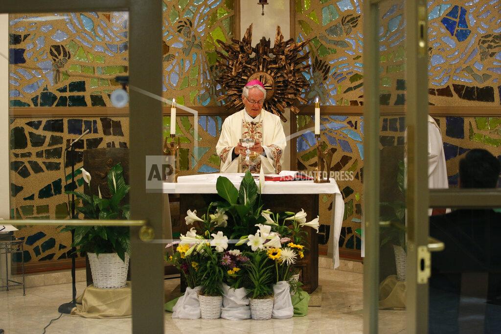 John Locher Bishop George Leo Thomas celebrates an Easter Vigil mass live-streamed from a small chapel without worshipers due to the coronavirus outbreak, Saturday, April 11, 2020, in Las Vegas. (AP Photo/John Locher)