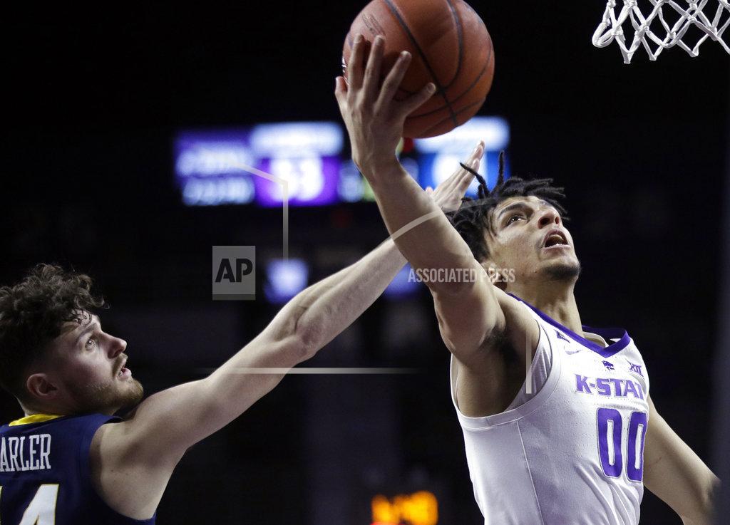 Orlin Wagner Kansas State guard Mike McGuirl (00) gets past West Virginia guard Chase Harler (14) for a basket during the second half of an NCAA college basketball game in Manhattan, Kan., Wednesday, Jan. 9, 2019. (AP Photo/Orlin Wagner)