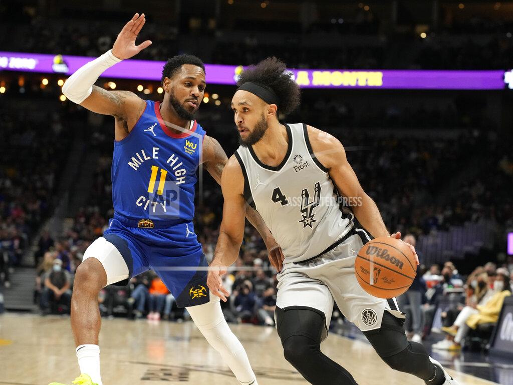 David Zalubowski San Antonio Spurs guard Derrick White, right, is defended by Denver Nuggets guard Monte Morris during the first half of an NBA basketball game Friday, Oct. 22, 2021, in Denver. (AP Photo/David Zalubowski)
