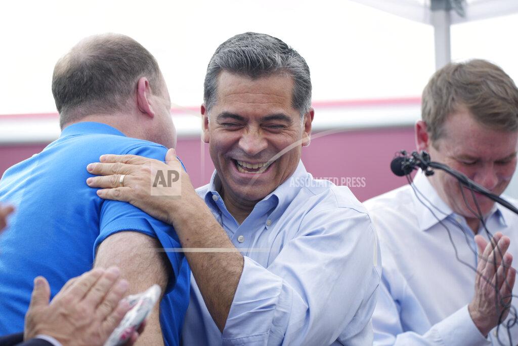 David Zalubowski U.S. Department of Health and Human Services Secretary Xavier Becerra, center, greets Colorado Gov. Jared Polis, left, and U.S. Sen. Michael Bennet, D-Colo., during a visit to a pair of buses set up as traveling clinics as part of the state's "Vaccines For All" campaign Friday, June 18, 2021, in Aurora, Colo. The buses are being used to distribute the COVID-19 vaccines. (AP Photo/David Zalubowski)