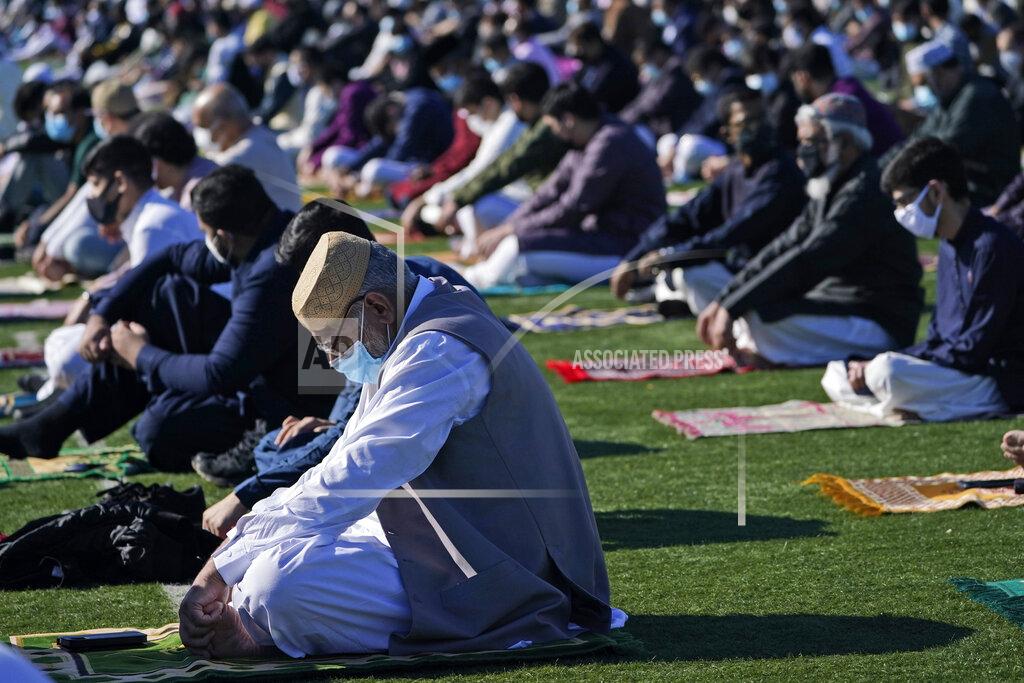 Seth Wenig People participate in Eid al-Fitr prayers in Overpeck County Park in Ridgefield Park, N.J., Thursday, May 13, 2021. Millions of Muslims across the world are marking a muted and gloomy holiday of Eid al-Fitr, the end of the fasting month of Ramadan - a usually joyous three-day celebration that has been significantly toned down as coronavirus cases soar. (AP Photo/Seth Wenig)