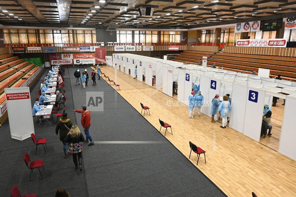 A view of the vaccination booths in the sports hall during vaccination of teachers in Trencin, Slovakia, on Sunday, February 14, 2021. Medical workers from the University Hospital Trencin have started vaccinating pedagogical staff against COVID-19, with more than 900 teachers receiving the vaccine. (Radovan Stoklasa/TASR via AP)