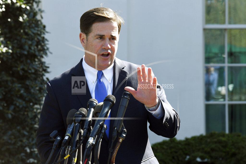 Susan Walsh FILE - In this April 3, 2019, file photo, Arizona Gov. Doug Ducey talks to reporters outside the West Wing of the White House in Washington. Ducey is yanking a grant of up to $1 million from Nike amid a report that the athletic company pulled a flag-themed shoe from the market. (AP Photo/Susan Walsh, File)