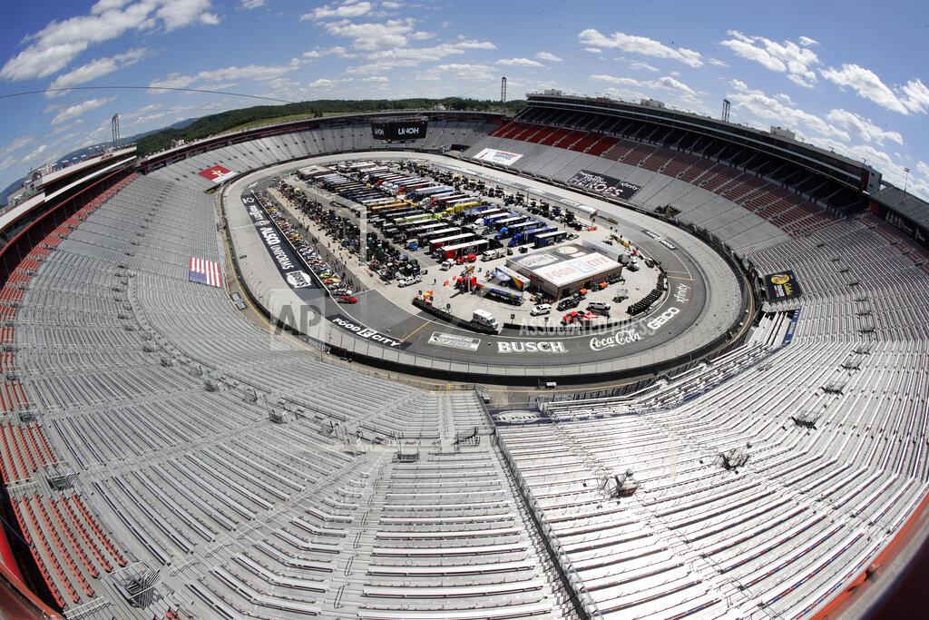 FILE - The stands sit empty as drivers prepare for the start of a NASCAR Cup Series auto race at Bristol Motor Speedway in Bristol, Tenn., in this May 31, 2020, file photo. Sports amid the pandemic became a whole different sort of spectacle, especially when it came to spectators — often with zero. (AP Photo/Mark Humphrey, File)
