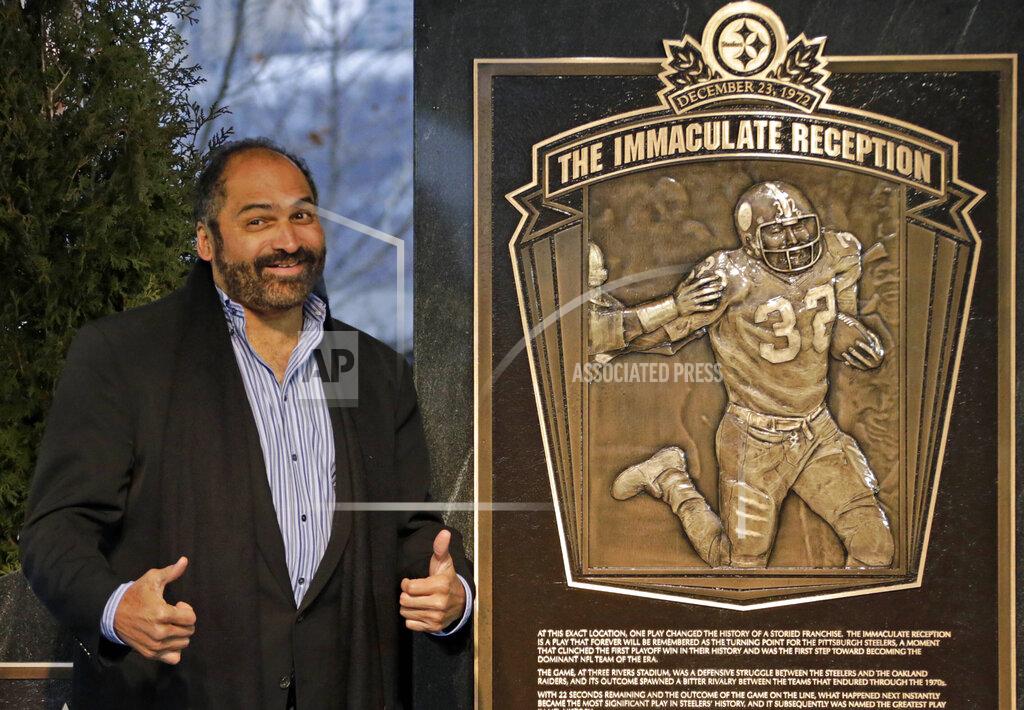 FILE - In this Dec. 22, 2012, file photo, former Pittsburgh Steelers Hall of Fame running back Franco Harris stands on the spot of the "Immaculate Reception" after a marker commemorating the 40th anniversary of the play was unveiled where Three Rivers Stadium once stood on the North Side of Pittsburgh. Harris’ scoop of a deflected pass and subsequent run for the winning touchdown in a 1972 playoff victory against Oakland _ has been voted the greatest play in NFL history. A nationwide panel of 68 media members chose the Immaculate Reception as the top play with 3,270 points and 39 first-place votes. (AP Photo/Gene J. Puskar, File)