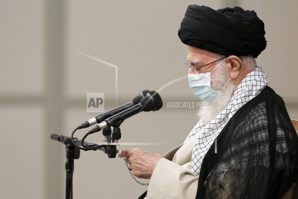 Uncredited In this photo released by an official website of the office of the Iranian supreme leader, Supreme Leader Ayatollah Ali Khamenei checks the time in farewell meeting with outgoing President Hassan Rouhani's administration in Tehran, Iran, Wednesday, July 28, 2021. Iran’s supreme leader called on Wednesday the U.S. “stubborn” installed nuclear talks in Vienna for discussing Tehran’s missiles and regional influence. (Office of the Iranian Supreme Leader via AP)