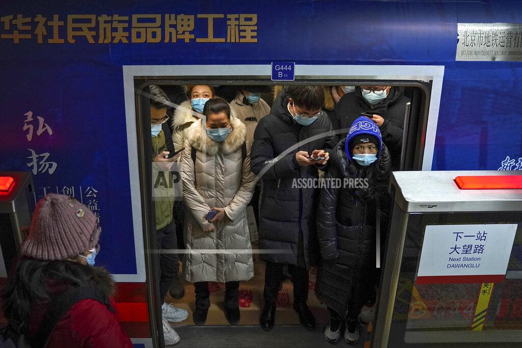 Andy Wong Commuters wearing face masks to help curb the spread of the coronavirus crowd inside a subway train during a rush hour in Beijing, Tuesday, Jan. 5, 2021. Wary of another wave of infections, China is urging tens of millions of migrant workers to stay put during next month's Lunar New Year holiday, usually the world's largest annual human migration. (AP Photo/Andy Wong)