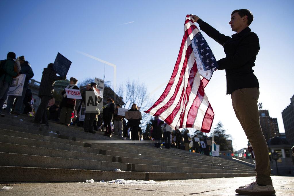 Matt Rourke FILE—In this file photo from Dec. 19, 2016, protesters demonstrate ahead of Pennsylvania's 58th Electoral College at the state Capitol in Harrisburg, Pa., Monday, Dec. 19, 2016. In 2016, the 20 unbound Electoral College members from Pennsylvania gathered in Harrisburg for Republican President-elect Donald Trump under pressure from Democrats to flip their vote to Democrat Hillary Clinton. This year, the 20 unbound Electoral College members from Pennsylvania will gather Monday in Harrisburg for Democratic President-elect Joe Biden, amid efforts by Trump to reverse the election result. (AP Photo/Matt Rourke, File)