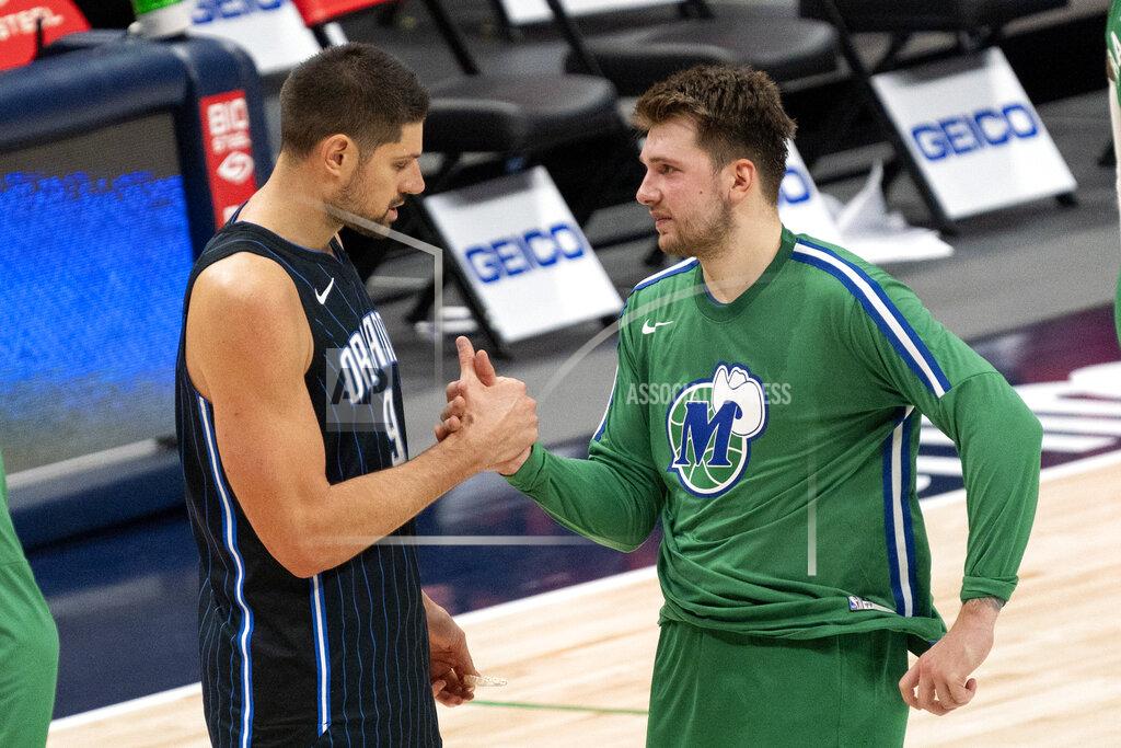 Jeffrey Mcwhorter Orlando Magic center Nikola Vucevic, left, and Dallas Mavericks guard Luka Doncic, right, shake hands on the court after an NBA basketball game, Saturday, Jan. 9, 2021, in Dallas. Dallas won 112-98. (AP Photo/Jeffrey McWhorter)
