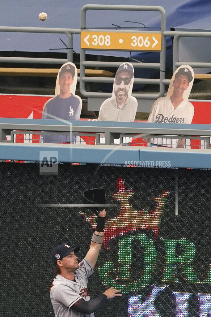 Ashley Landis Houston Astros right fielder Josh Reddick reaches for a home run hit by Los Angeles Dodgers' Chris Taylor during the second inning of a baseball game at Dodger Stadium on Saturday, Sept. 12, 2020, in Los Angeles. (AP Photo/Ashley Landis)