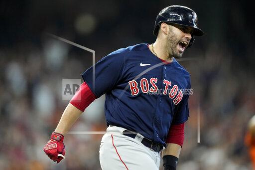 Boston Red Sox's J.D. Martinez celebrates his grand slam against the Houston Astros during the first inning in Game 2 of baseball's American League Championship Series Saturday, Oct. 16, 2021, in Houston. (AP Photo/David J. Phillip)