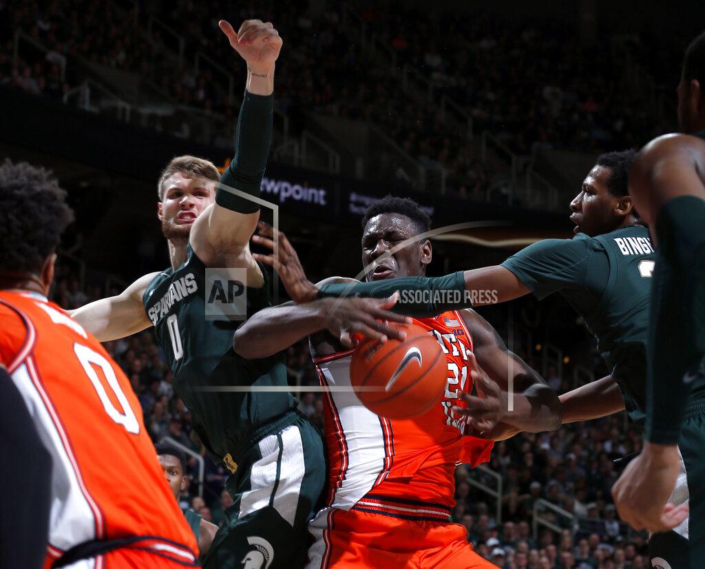 Al Goldis Illinois' Kofi Cockburn, center, and Michigan State's Kyle Ahrens, left, and Marcus Bingham Jr., right, compete for a rebound during the first half of an NCAA college basketball game Thursday, Jan. 2, 2020, in East Lansing, Mich. (AP Photo/Al Goldis)