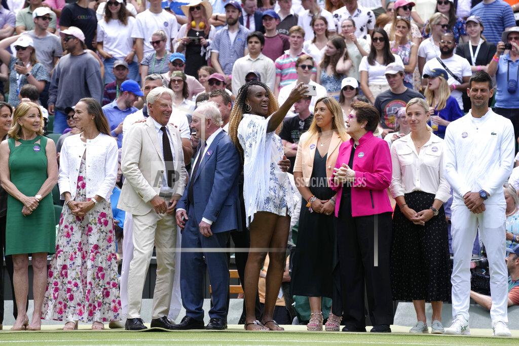 Kirsty Wigglesworth Venus Williams takes a photo standing between U.S. tennis legend Billie Jean King and Rod Laver during a 100 years of Centre Court celebration on day seven of the Wimbledon tennis championships in London, Sunday, July 3, 2022. (AP Photo/Kirsty Wigglesworth)