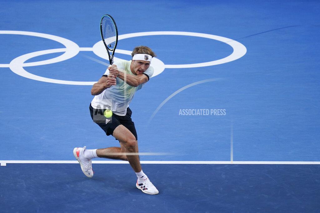 Alexander Zverev, of Germany, returns a shot to Karen Khachanov, of the Russian Olympic Committee, during the men's single gold medal match of the tennis competition at the 2020 Summer Olympics, Sunday, Aug. 1, 2021, in Tokyo, Japan. (AP Photo/Seth Wenig)